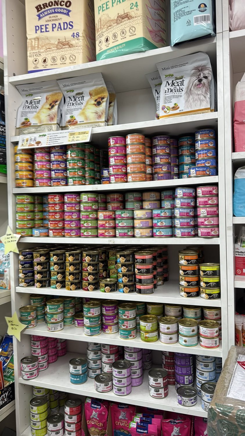Shelves of wet cat and dog food in a pet store