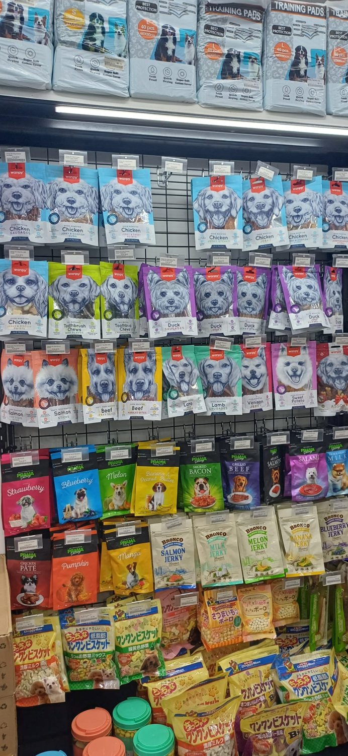 A wall of pet treats and snacks in a pet store